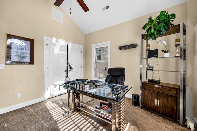 home office with high vaulted ceiling, baseboards, visible vents, and light colored carpet