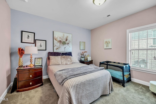 carpeted bedroom with visible vents and baseboards