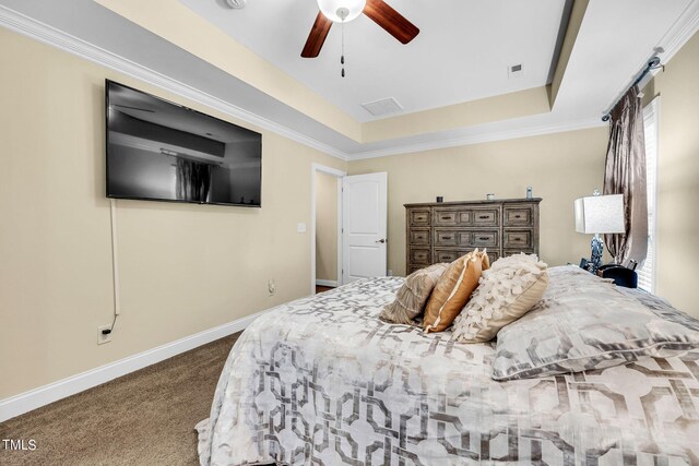 bedroom featuring a ceiling fan, dark colored carpet, a raised ceiling, and baseboards