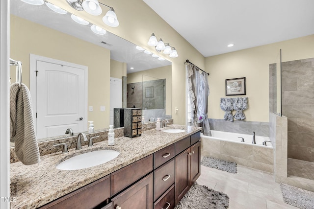 bathroom with a bath, double vanity, a walk in shower, and a sink