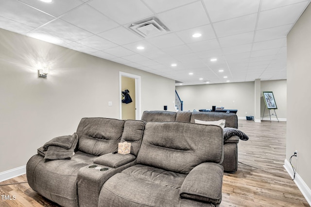 living room featuring wood finished floors, visible vents, and baseboards