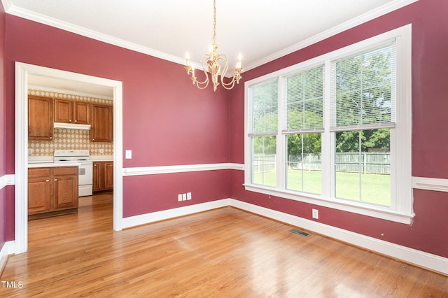 unfurnished dining area with light hardwood / wood-style flooring, plenty of natural light, a chandelier, and ornamental molding