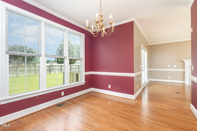 unfurnished room with crown molding, vaulted ceiling, hardwood / wood-style floors, and a chandelier