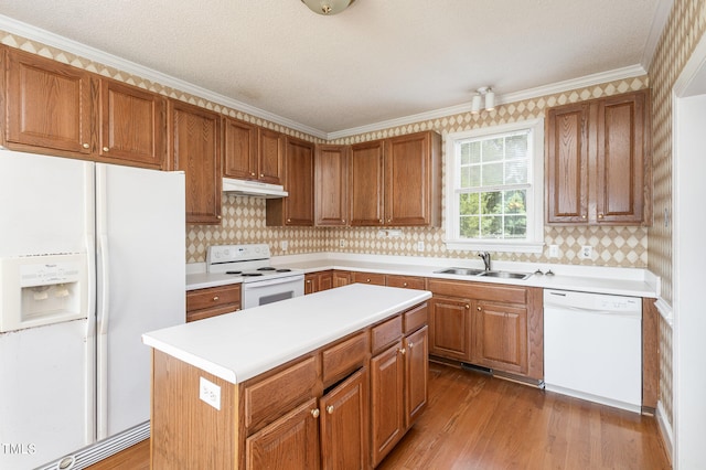 kitchen featuring sink, white appliances, hardwood / wood-style flooring, and decorative backsplash