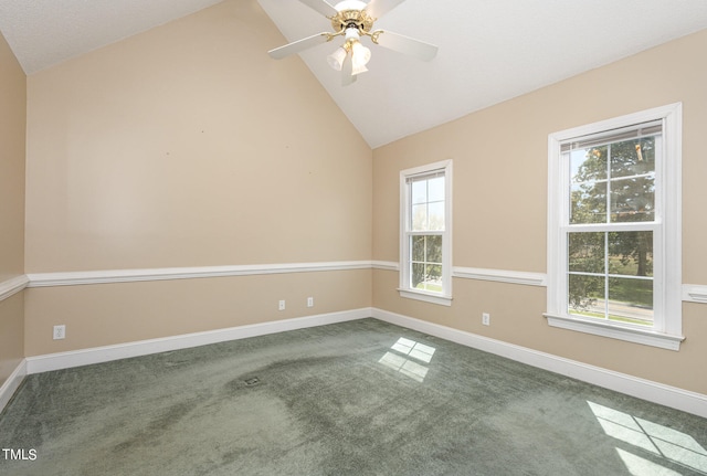 unfurnished room featuring a wealth of natural light, carpet flooring, ceiling fan, and lofted ceiling