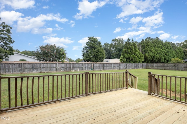 wooden terrace featuring a lawn