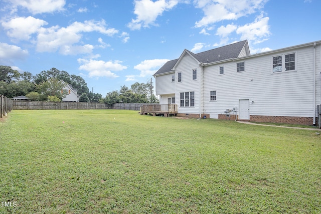 back of house with a yard and a deck