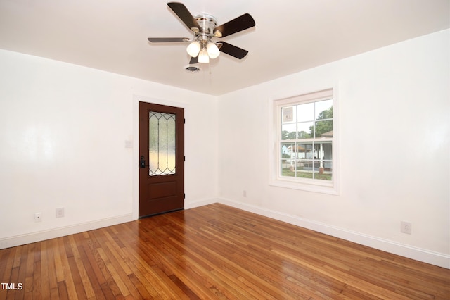 empty room with ceiling fan and wood-type flooring