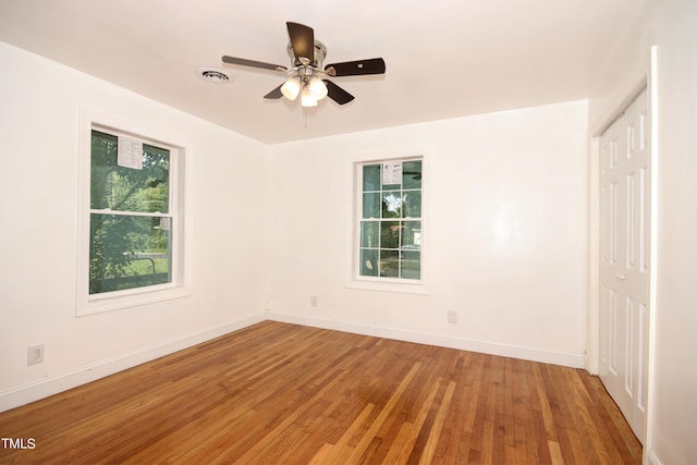 unfurnished room with wood-type flooring and ceiling fan