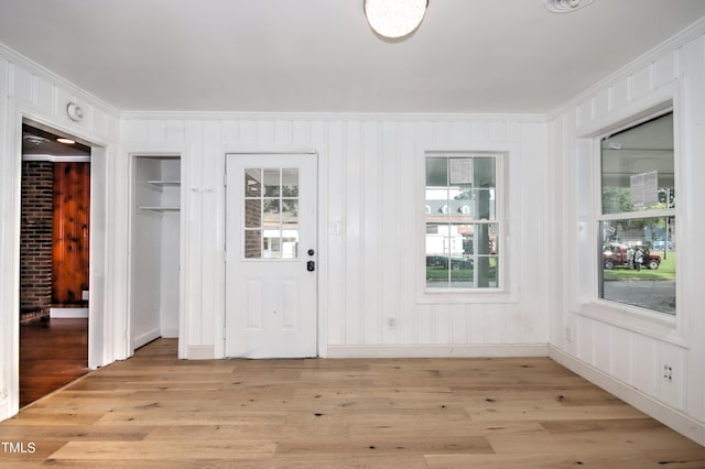 foyer entrance featuring ornamental molding and light hardwood / wood-style floors