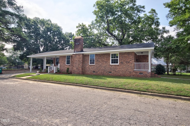 ranch-style house with covered porch and a front lawn