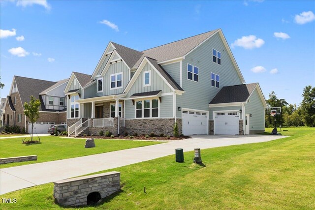 craftsman house with a garage, covered porch, and a front yard