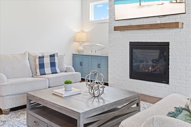 living room featuring light hardwood / wood-style flooring and a fireplace