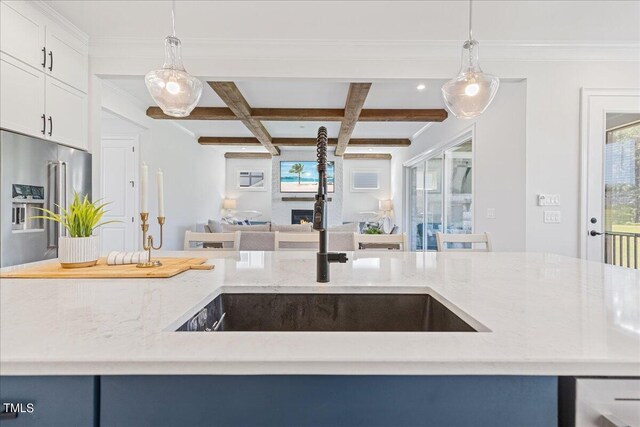 kitchen with pendant lighting, coffered ceiling, high end refrigerator, and beamed ceiling