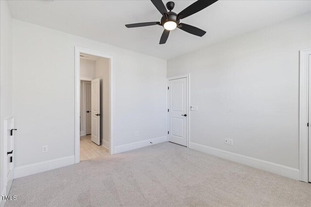 unfurnished bedroom featuring ceiling fan and light carpet