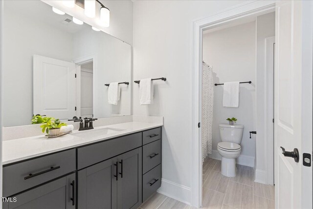 bathroom featuring vanity and toilet