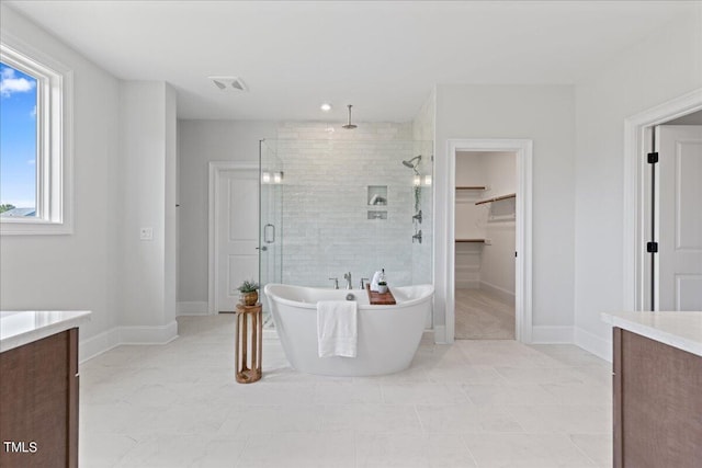 bathroom featuring vanity, separate shower and tub, and tile patterned floors