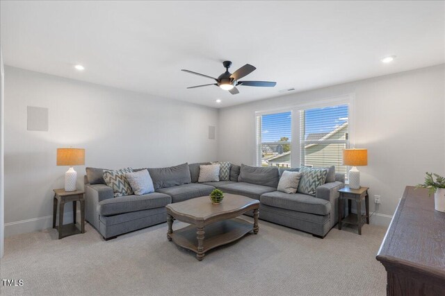 living room featuring light carpet and ceiling fan