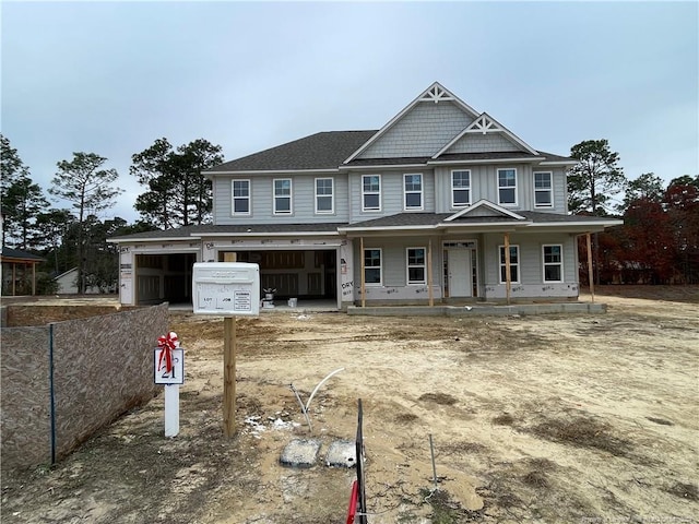 view of front of property featuring covered porch and a garage