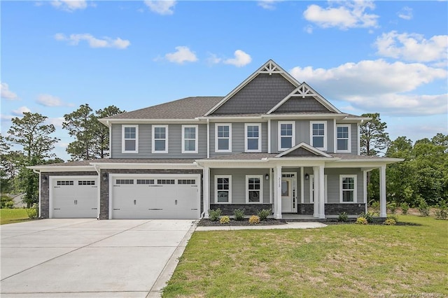 3113 Cragburn Pl, Fayetteville, NC 28306 - view of front facade with driveway, a front lawn, covered porch, stone siding, and an attached garage