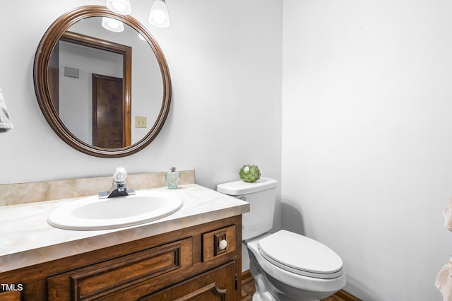 bathroom with toilet and vanity