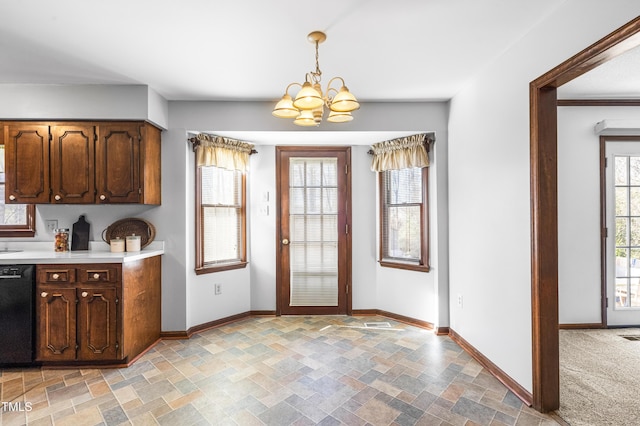 kitchen featuring pendant lighting, dishwasher, and an inviting chandelier