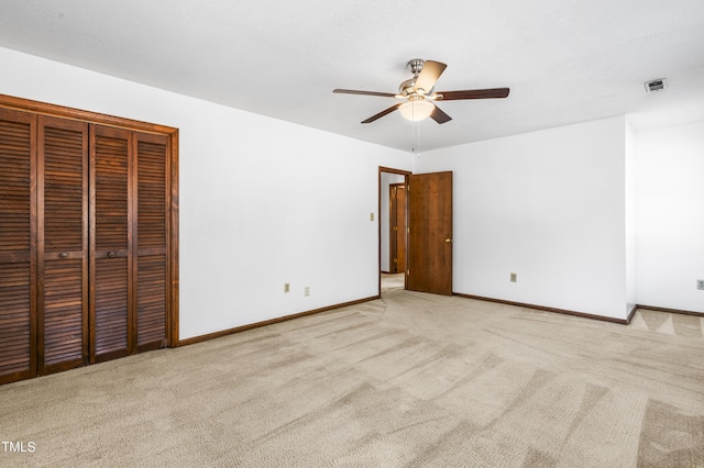 unfurnished bedroom featuring ceiling fan and light carpet