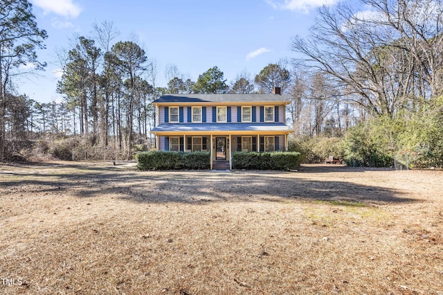 view of front of home with covered porch and a front yard