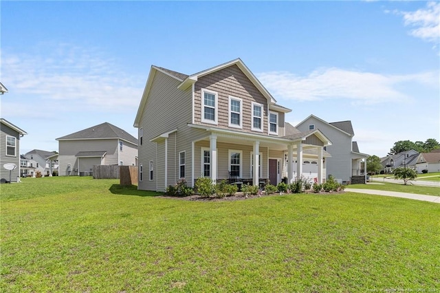 view of front of house with a garage, a front lawn, and covered porch