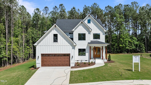 100 N Ridge View Way, Franklinton, NC 27525 - modern farmhouse style home with board and batten siding, an attached garage, driveway, a front yard, and a shingled roof
