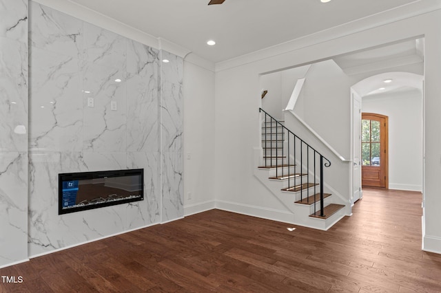 100 N Ridge View Way, Franklinton, NC 27525 - unfurnished living room with wood finished floors, arched walkways, baseboards, stairway, and recessed lighting