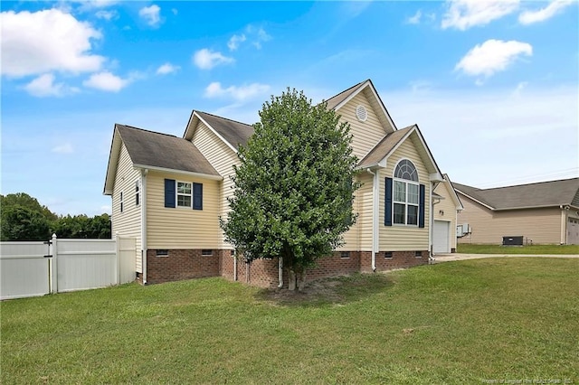 view of side of home featuring a yard and central AC