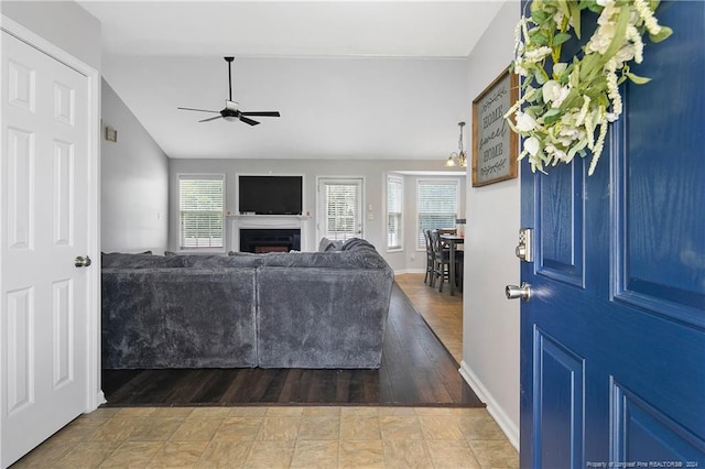 living room featuring wood-type flooring and ceiling fan