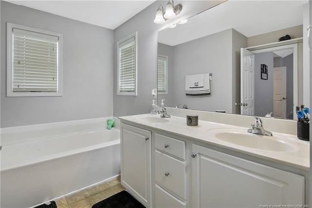 bathroom with a bath and vanity