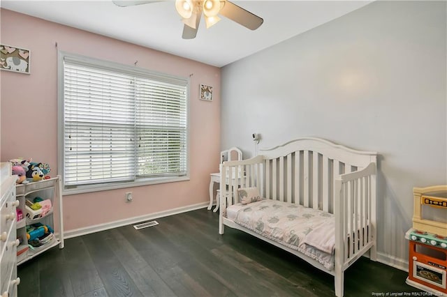 bedroom with ceiling fan and dark hardwood / wood-style floors