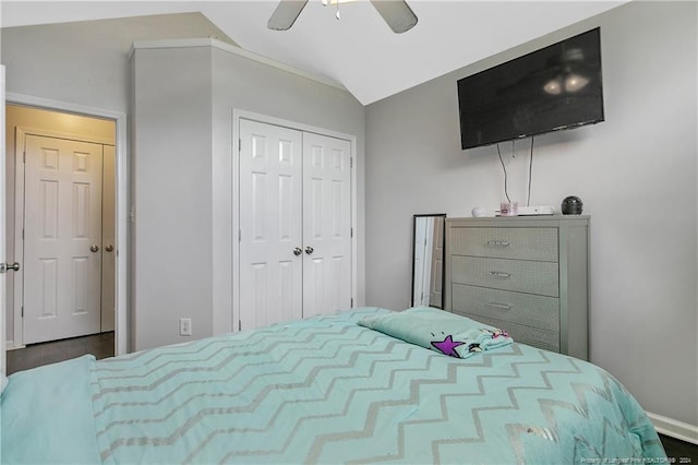 bedroom featuring lofted ceiling, a closet, ceiling fan, and wood-type flooring