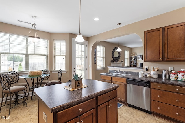 kitchen featuring plenty of natural light, stainless steel dishwasher, and light tile patterned floors