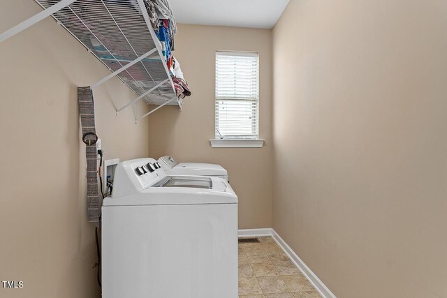 washroom with washing machine and dryer and light tile patterned floors