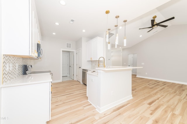 kitchen with light hardwood / wood-style floors, stainless steel appliances, decorative backsplash, and ceiling fan