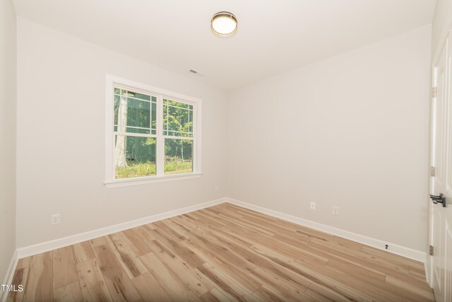 unfurnished room with light hardwood / wood-style floors