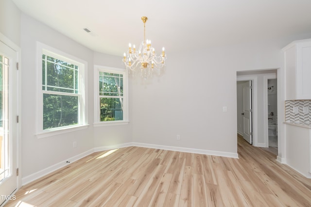 interior space featuring light wood-type flooring and a notable chandelier