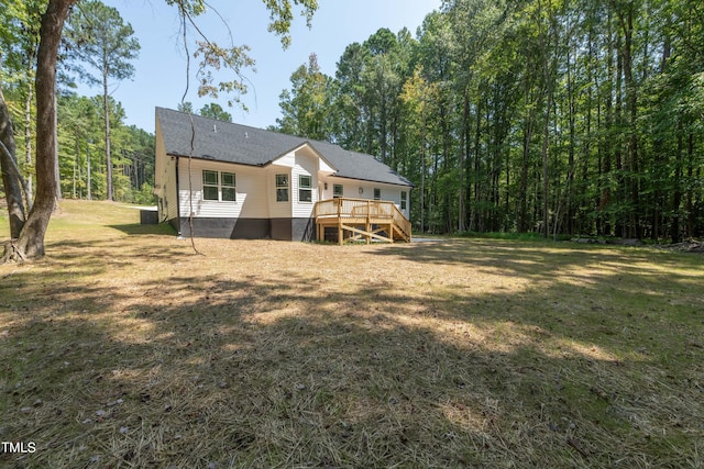 back of house with a wooden deck and a yard