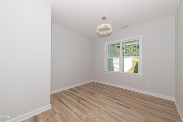 empty room with light hardwood / wood-style floors