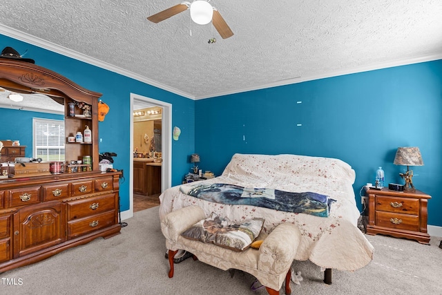 carpeted bedroom with ceiling fan, ornamental molding, a textured ceiling, and ensuite bathroom