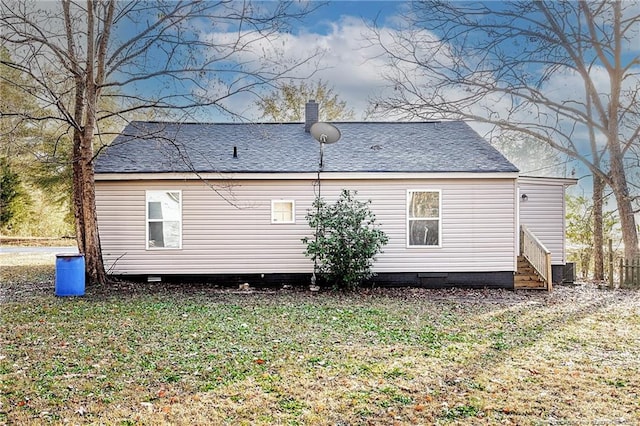 rear view of house with a lawn