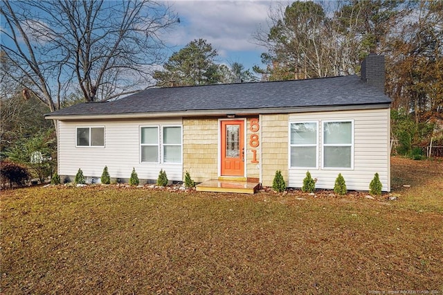 ranch-style house featuring a front lawn