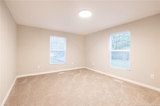 unfurnished room with light colored carpet