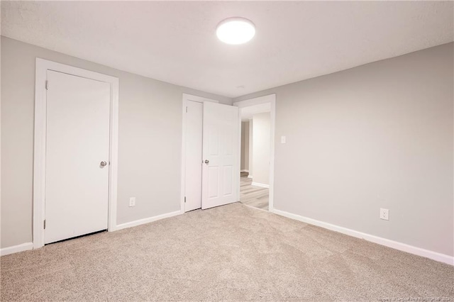 unfurnished bedroom with light colored carpet