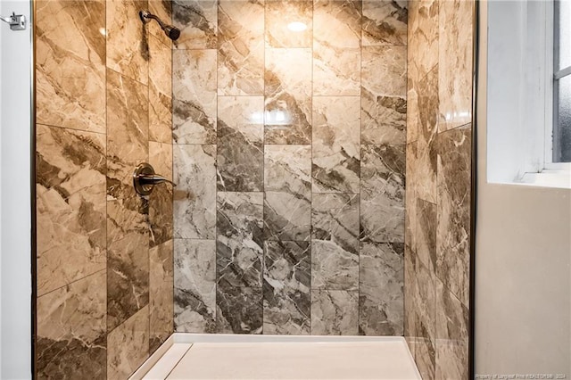 bathroom with a tile shower