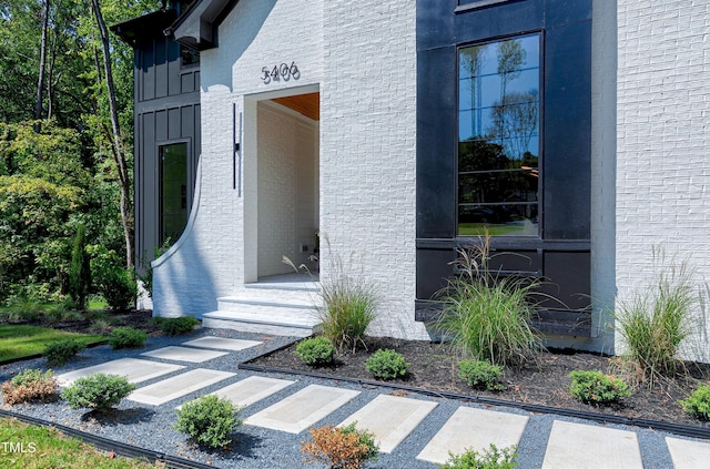 property entrance featuring board and batten siding